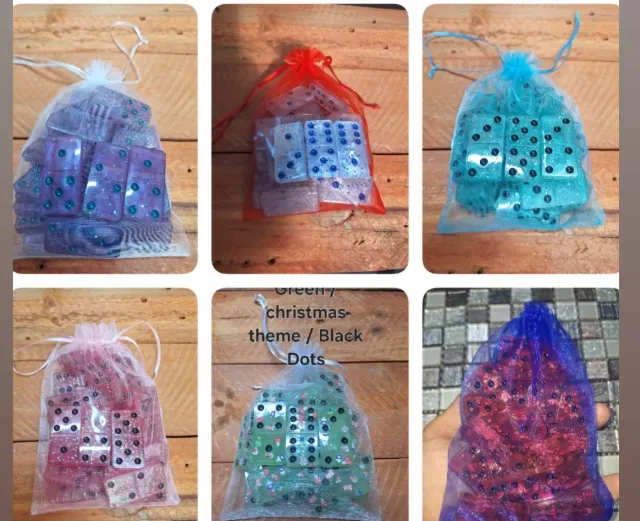 Six domino sets in organza drawstring bags